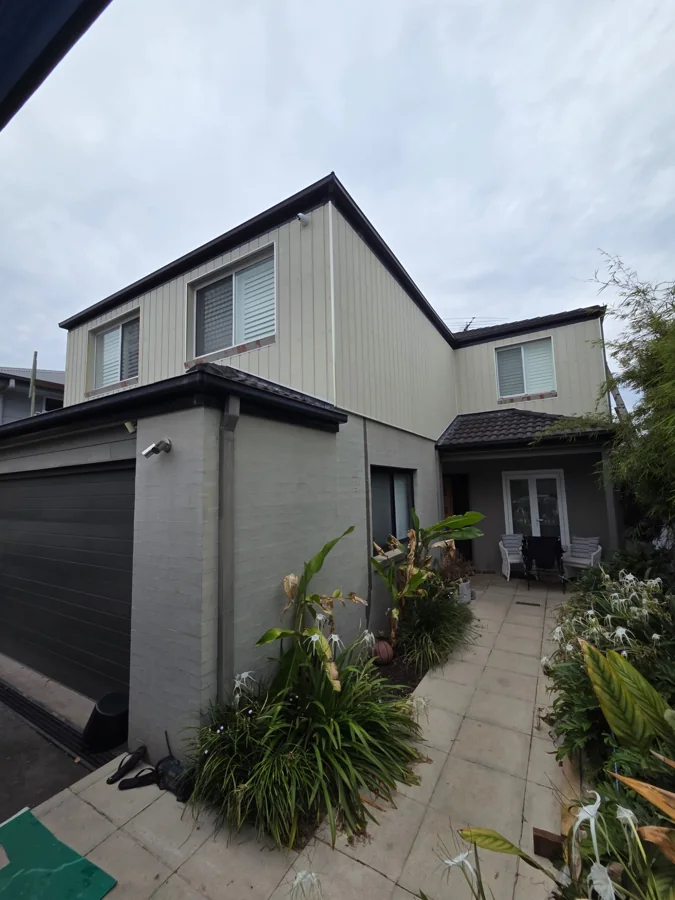 New exterior cladding being prepared for painting at a Fairlight home