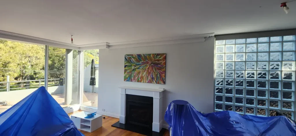 Furniture covered for painting inside the Mosman home