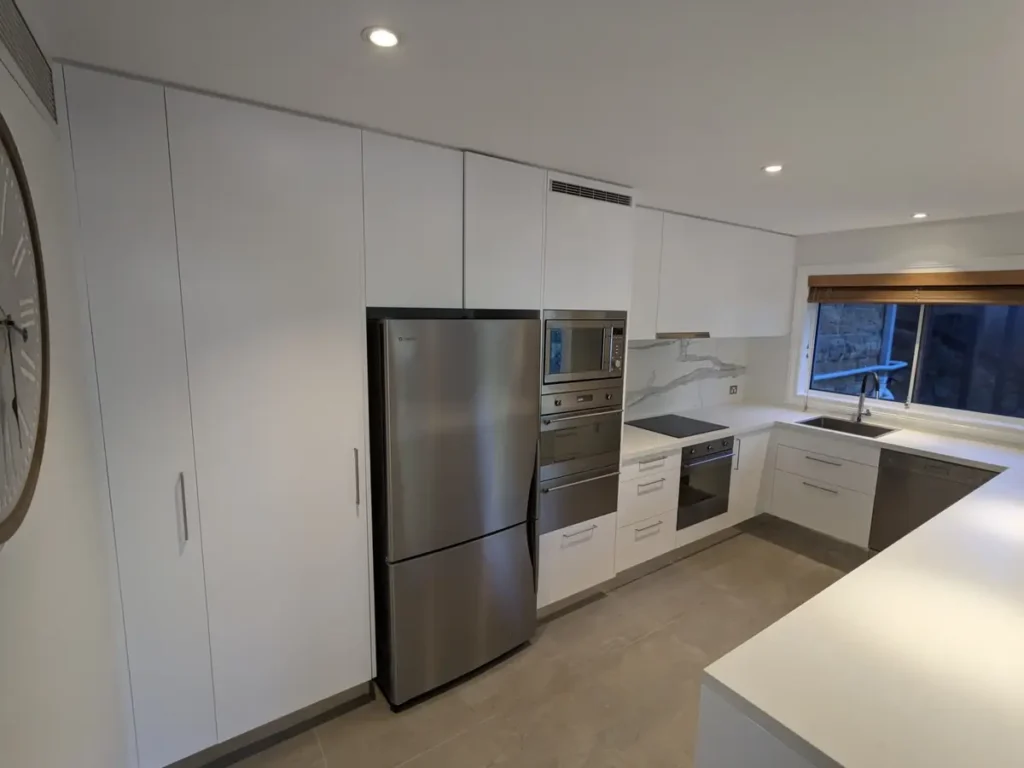Finished white kitchen cabinets inside the Mosman home