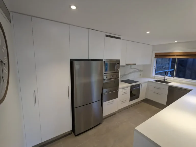 Finished white kitchen cabinets inside the Mosman home