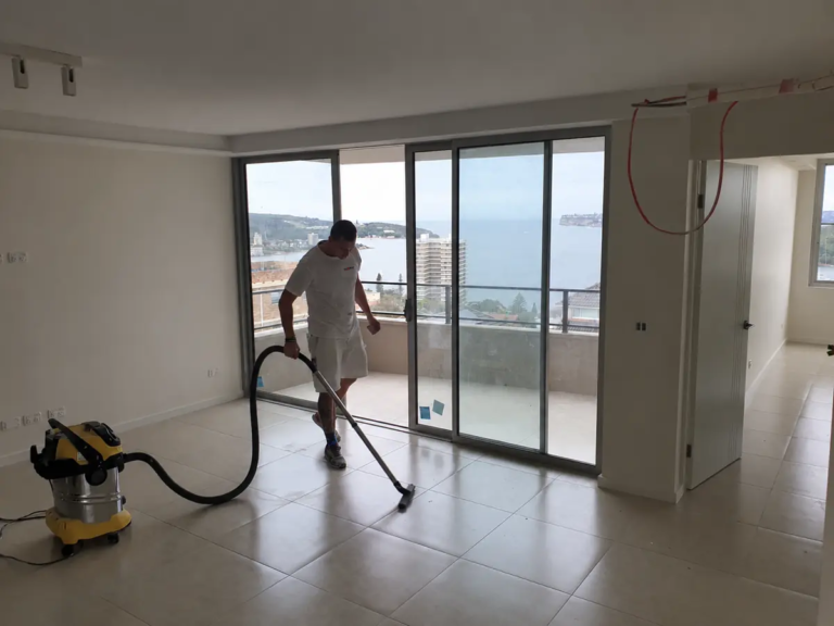 Vakker team member vacuuming a freshly painted apartment in Fairlight, NSW.